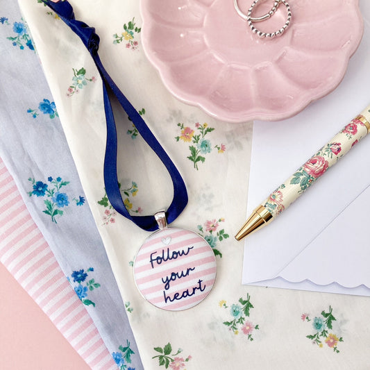 Follow your heart keepsake made with pink and white striped fabric on a navy blue ribbon