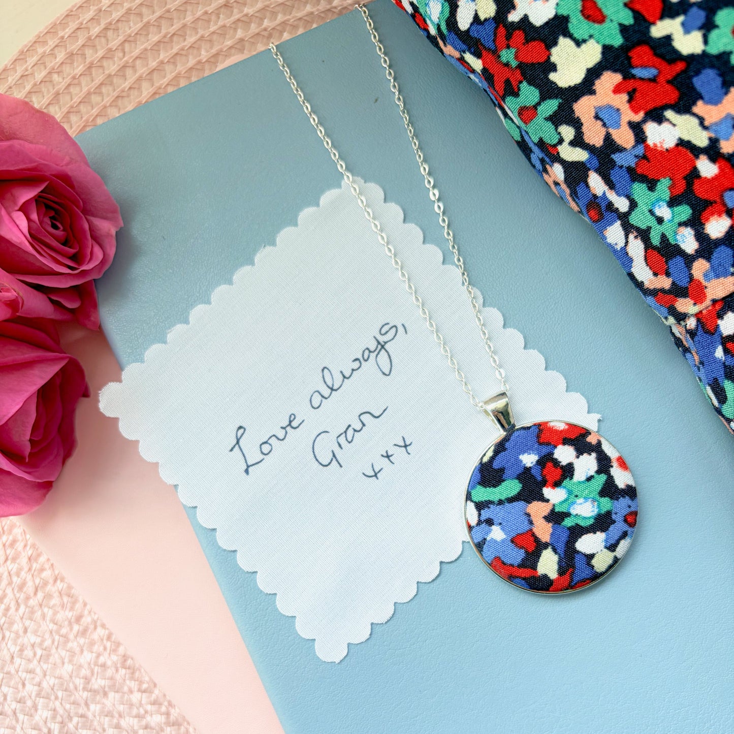 Colourful fabric pendant with a fabric handwriting message saying Love Always Gran