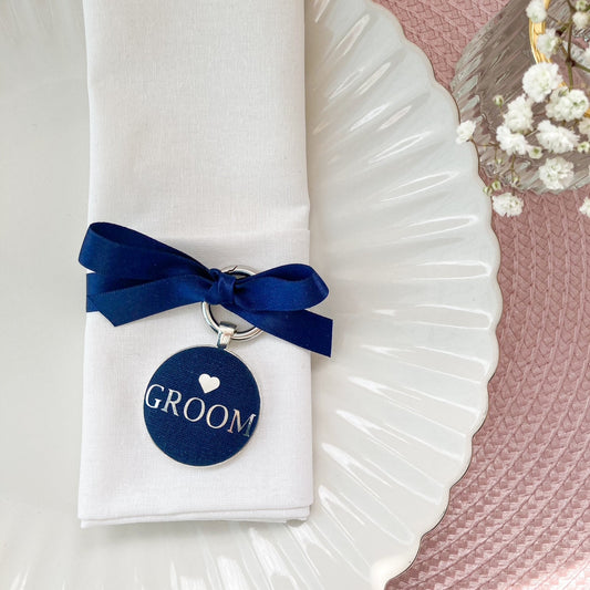 Groom wedding place setting and favour in navy blue linen fabric with navy ribbon
