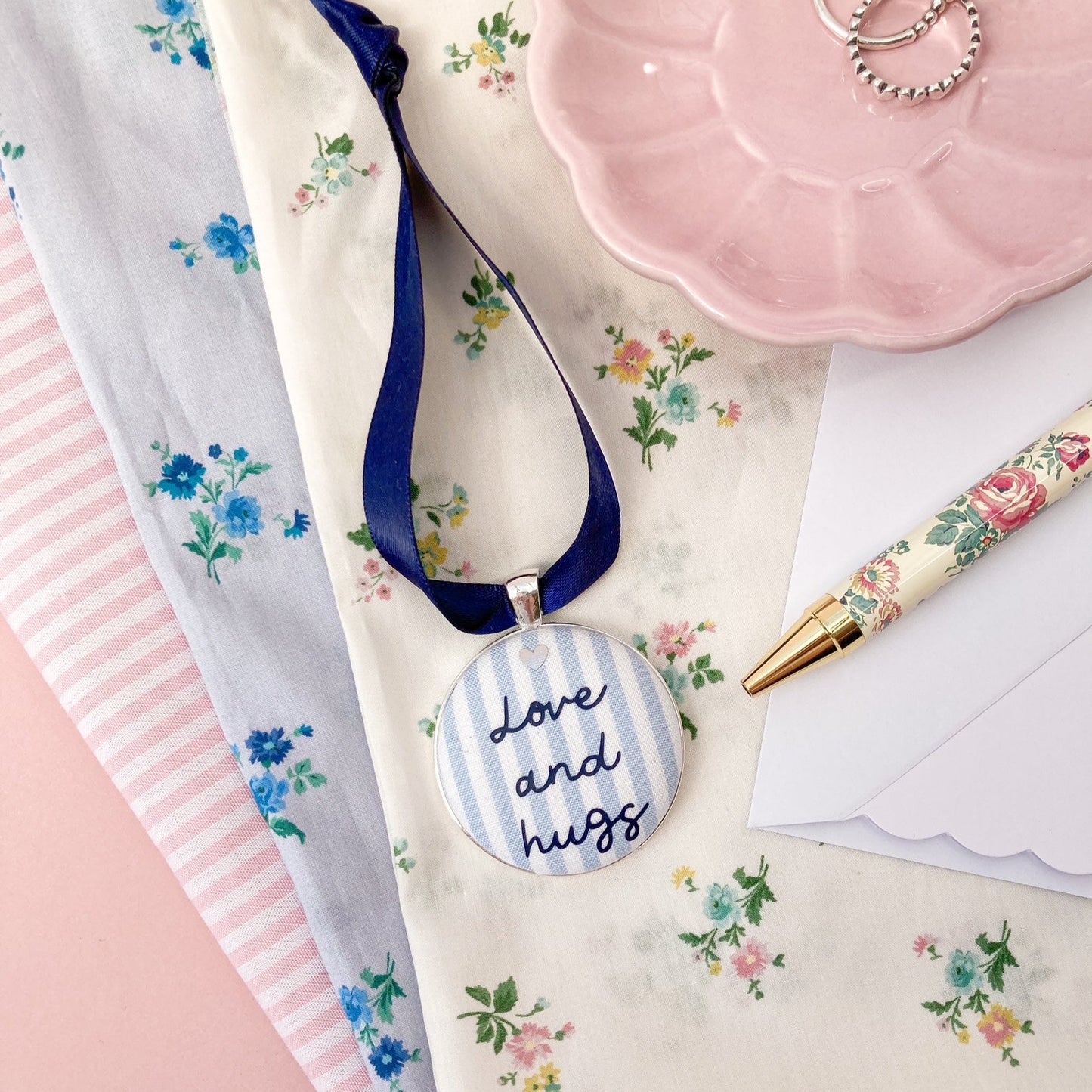 Love and Hugs keepsake made with blue and white striped fabric and a navy blue ribbon