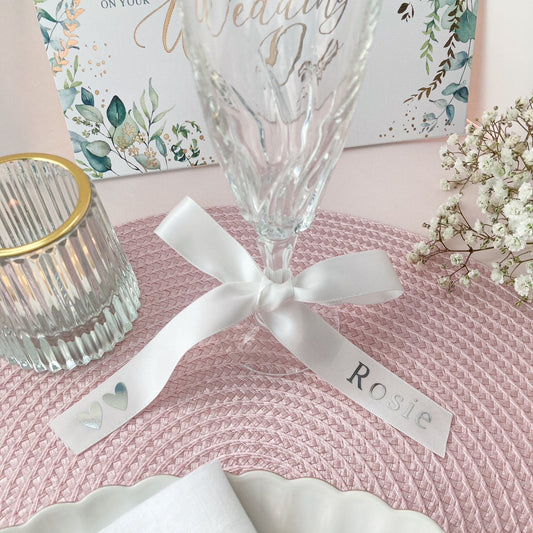 Personalised glass ribbons for wedding breakfast in white with printed name in silver