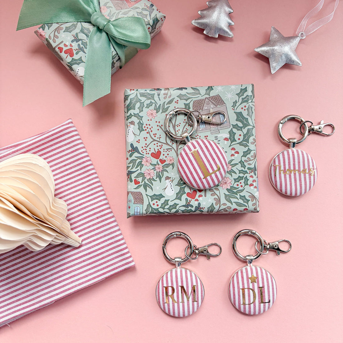 Christmas personalised keyrings made with striped red fabric and gold initials or names