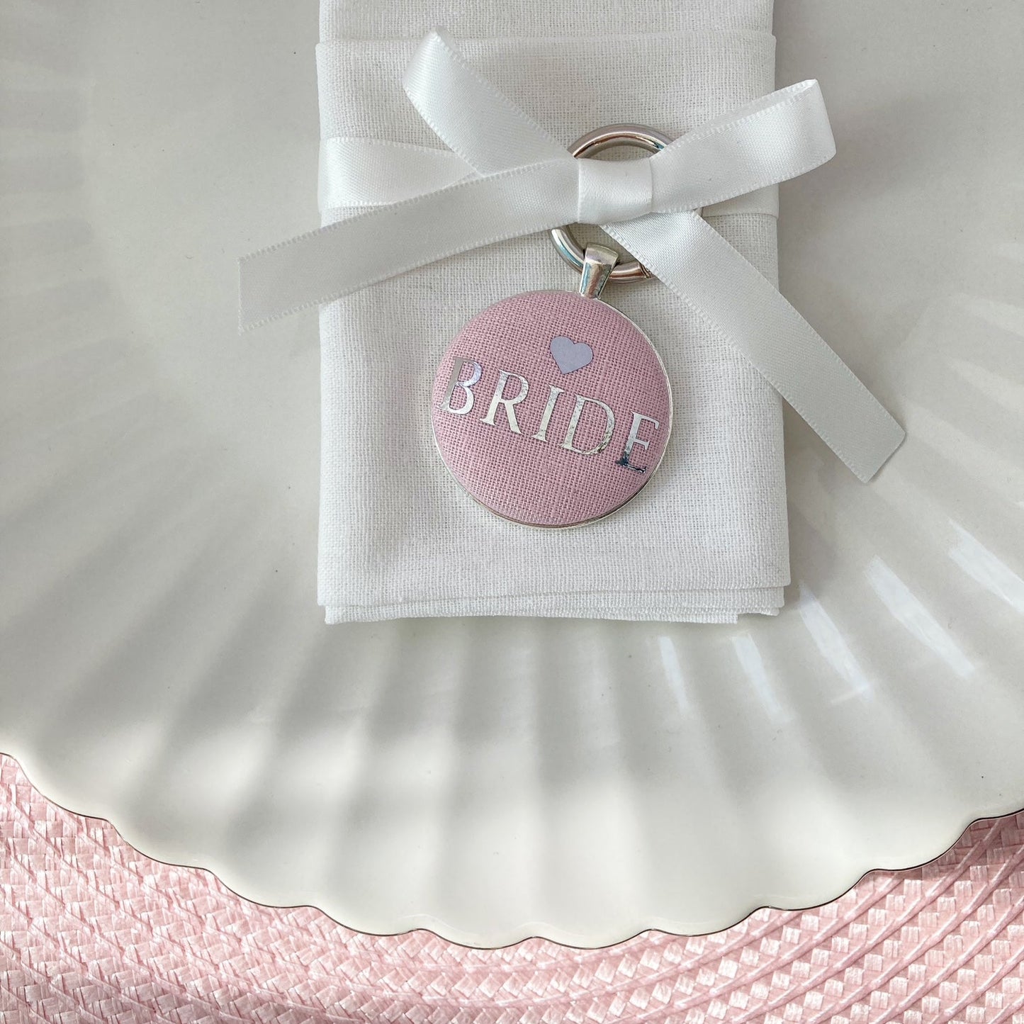 Bride wedding place setting and keepsake in pink linen fabric with ribbon