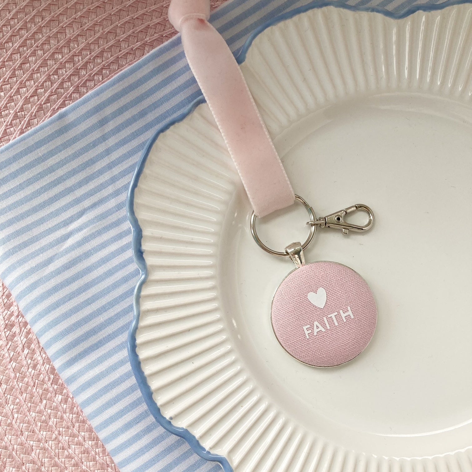 Pink keepsake and keyring thread on a velvet ribbon with 'FAITH' and a white heart printed onto pink fabric