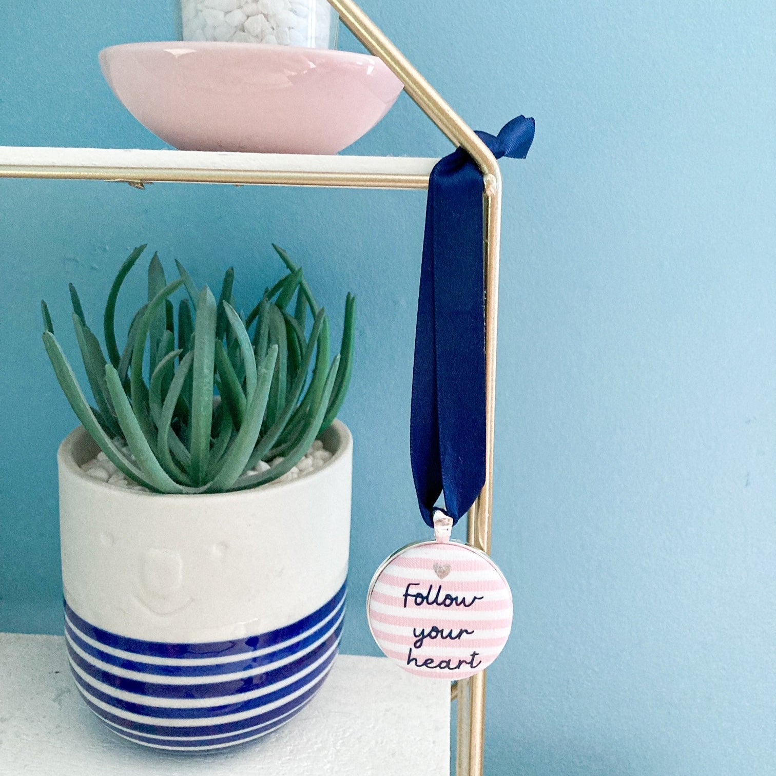 Follow your heart keepsake on pink and white striped fabric with a navy blue ribbon