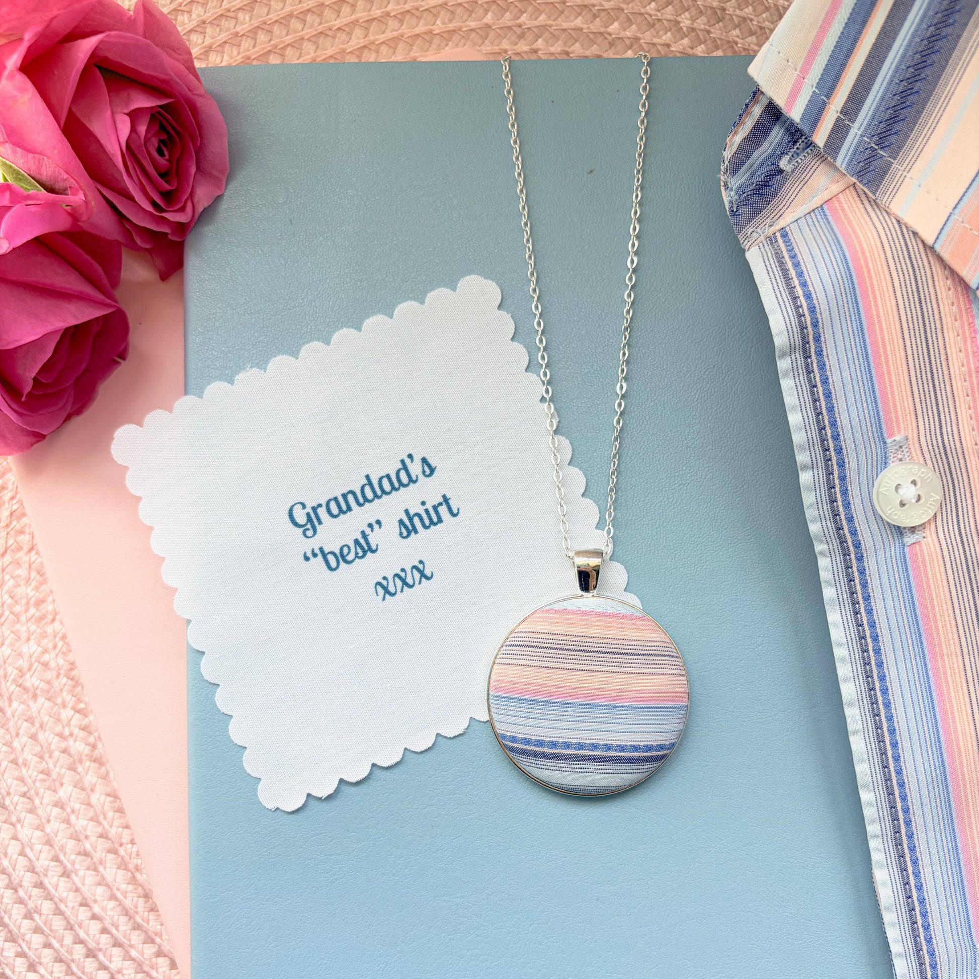 Necklace with a colorful pendant  with 'Grandad's 'best' shirt' fabric message, surrounded by flowers and a shirt.