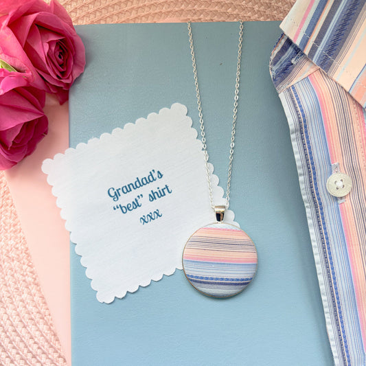 Necklace with a colorful pendant  with 'Grandad's 'best' shirt' fabric message, surrounded by flowers and a shirt.
