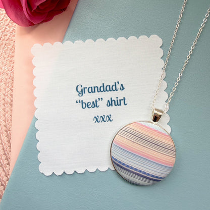 Necklace with a striped pendant that reads 'Grandad's best shirt' with a pink rose in the background.