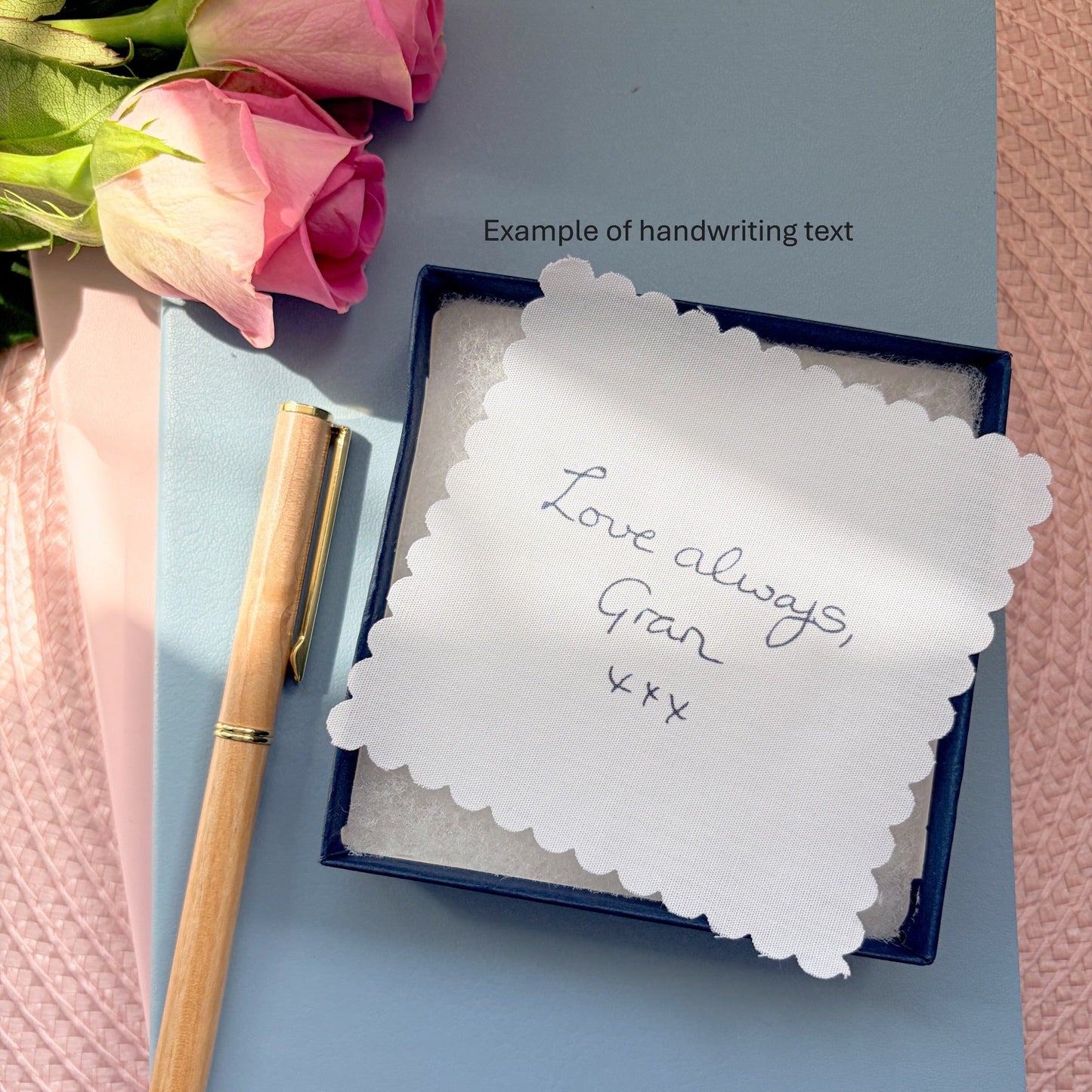 Grans dress memory keepsake giftbox and fabric message, set on a blue notebook with pen and rose