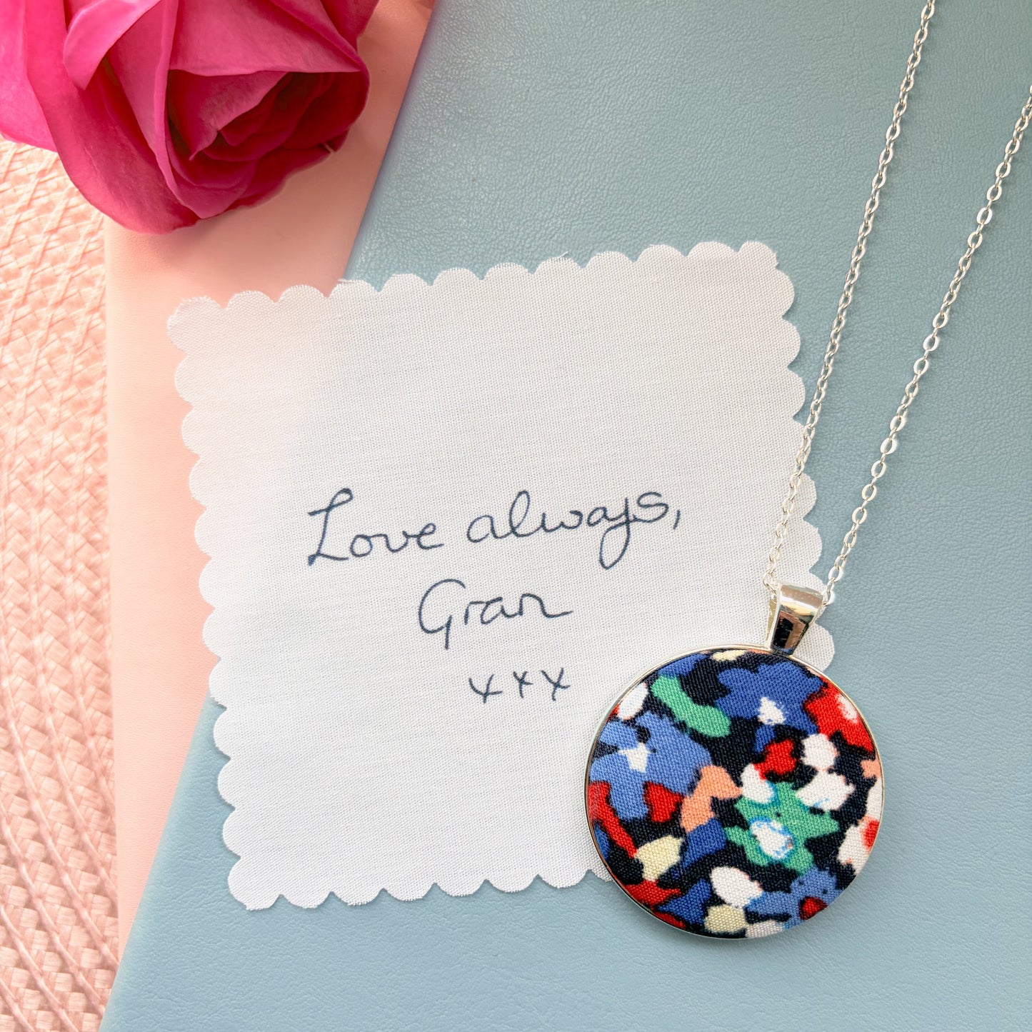 Colourful fabric pendant with a fabric handwriting message saying Love Always Gran