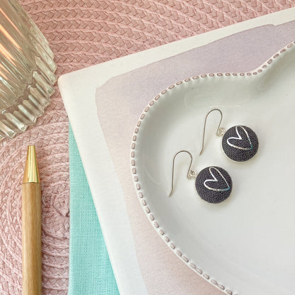 Graphite grey fabric hook earrings with silver heart design