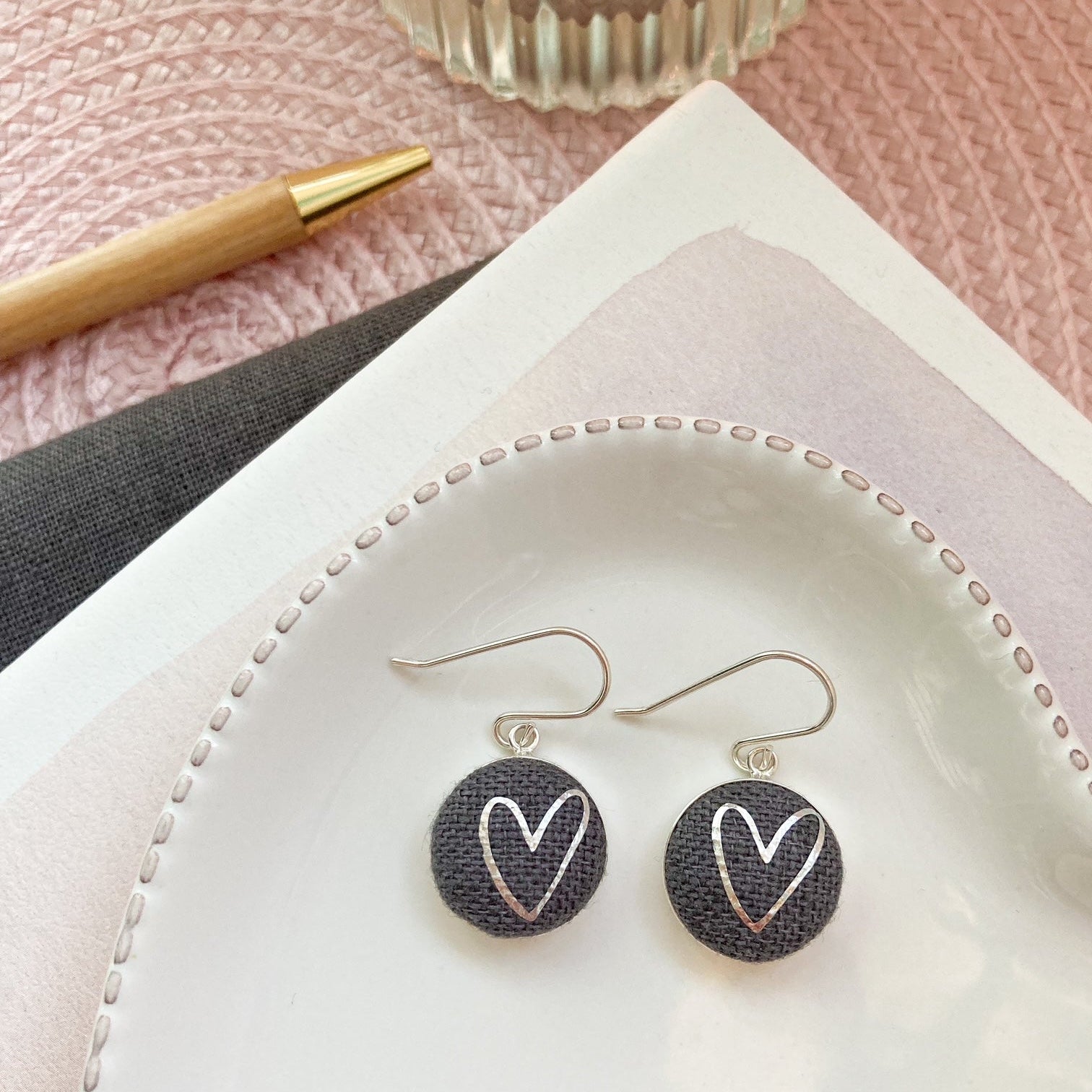 Graphite grey fabric hook earrings with silver heart design