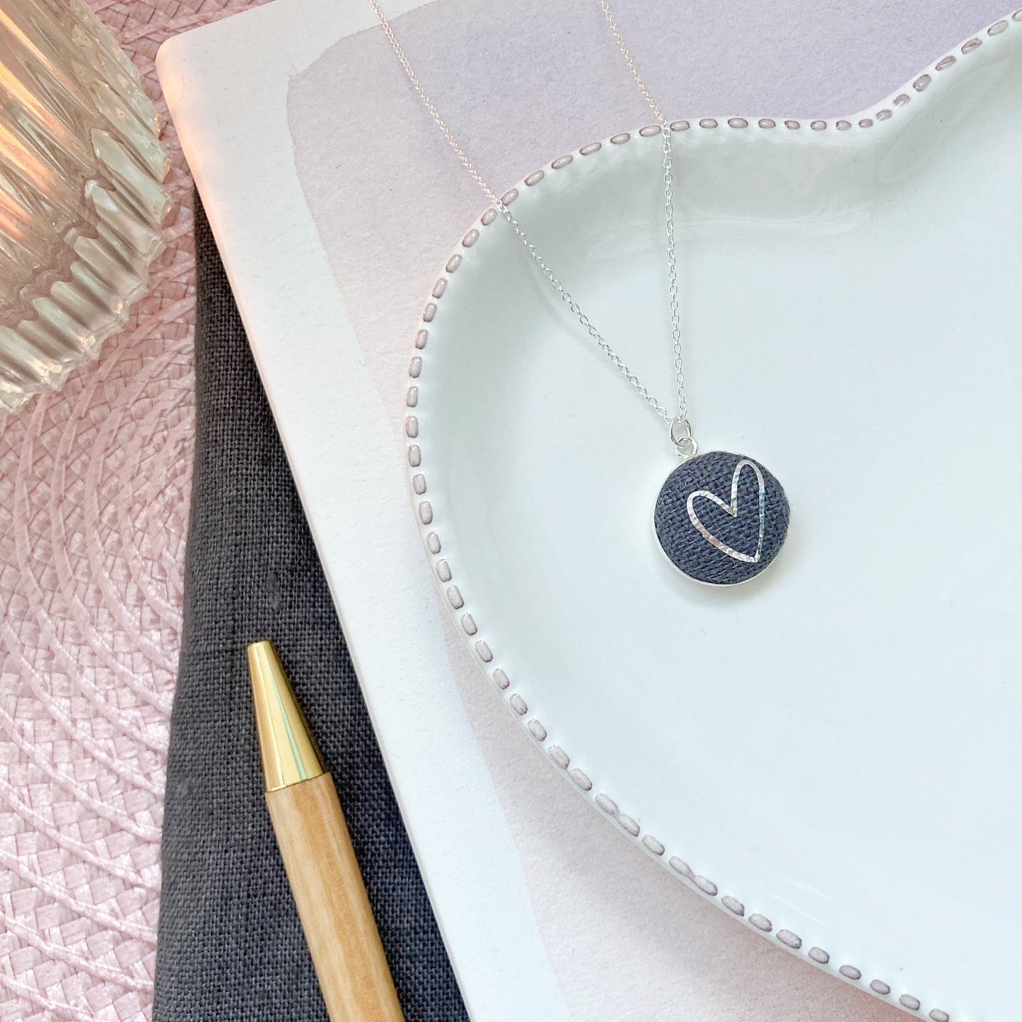 Necklace with a heart pendant on a textured surface