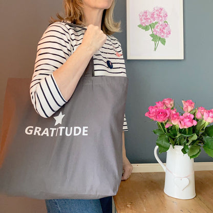 Large grey tote bag with Gratitude printed in white