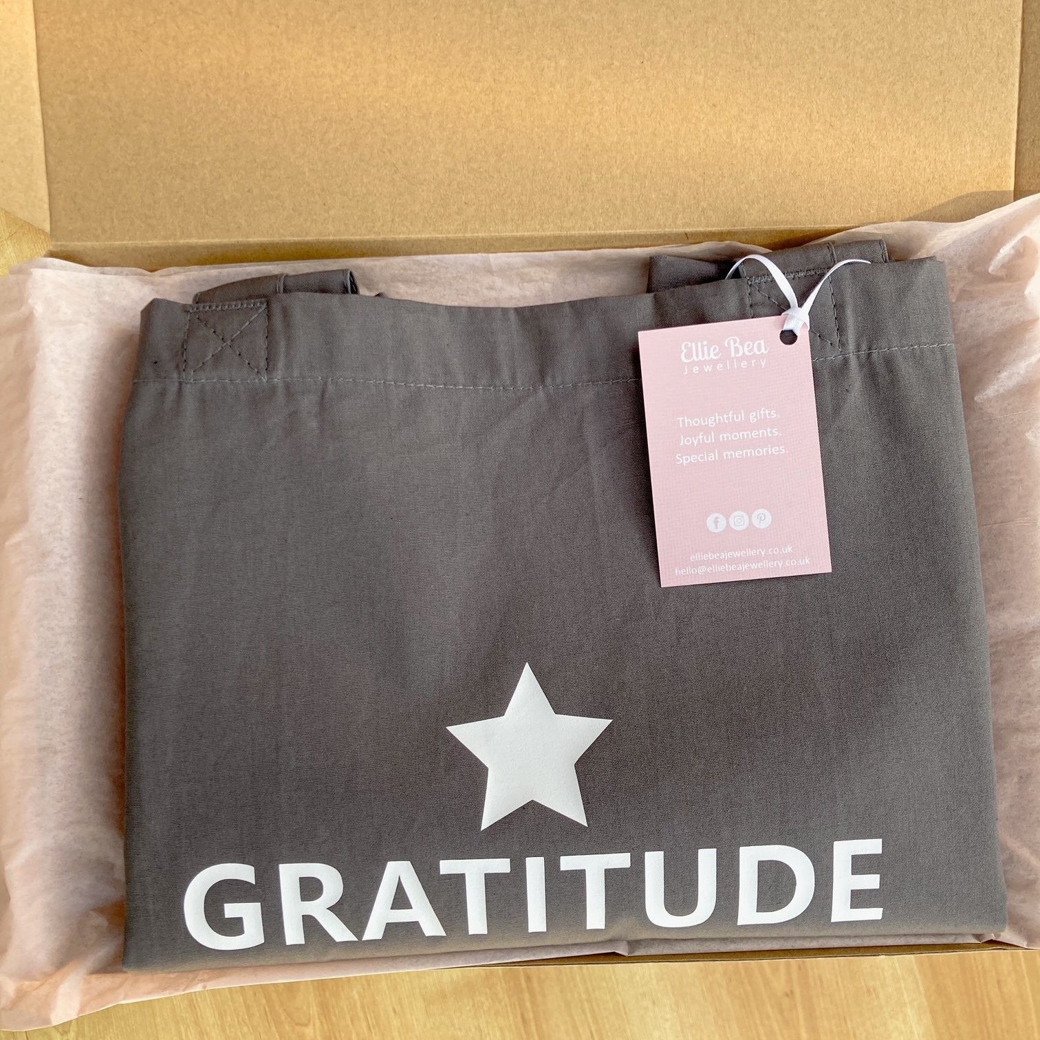 Gratitude tote bag wrapped in tissue paper in a mailing box