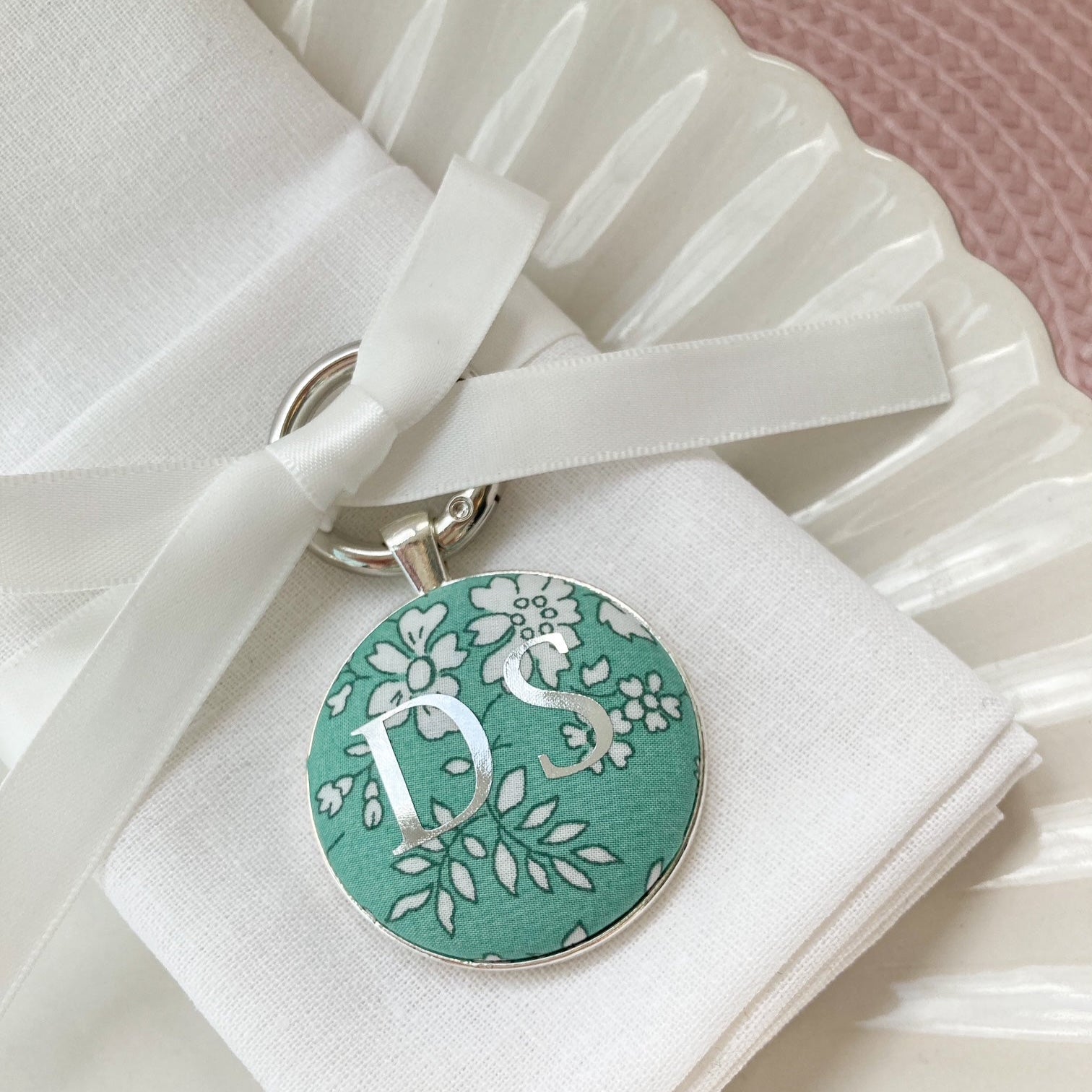 Green floral wedding breakfast place setting and favour made with Liberty fabric