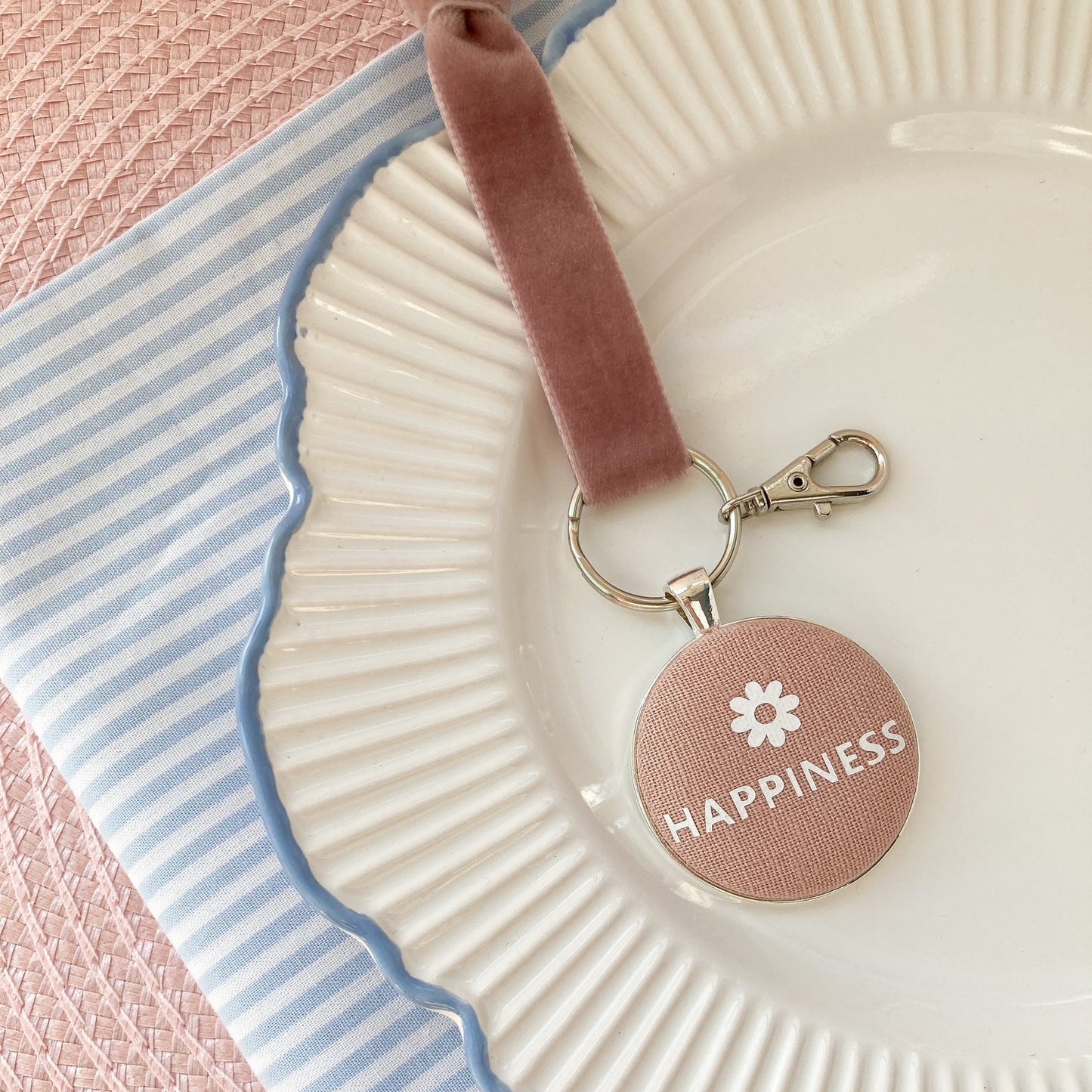 Key ring and keepsake with 'Happiness' and flower symbol on a pink blush fabric