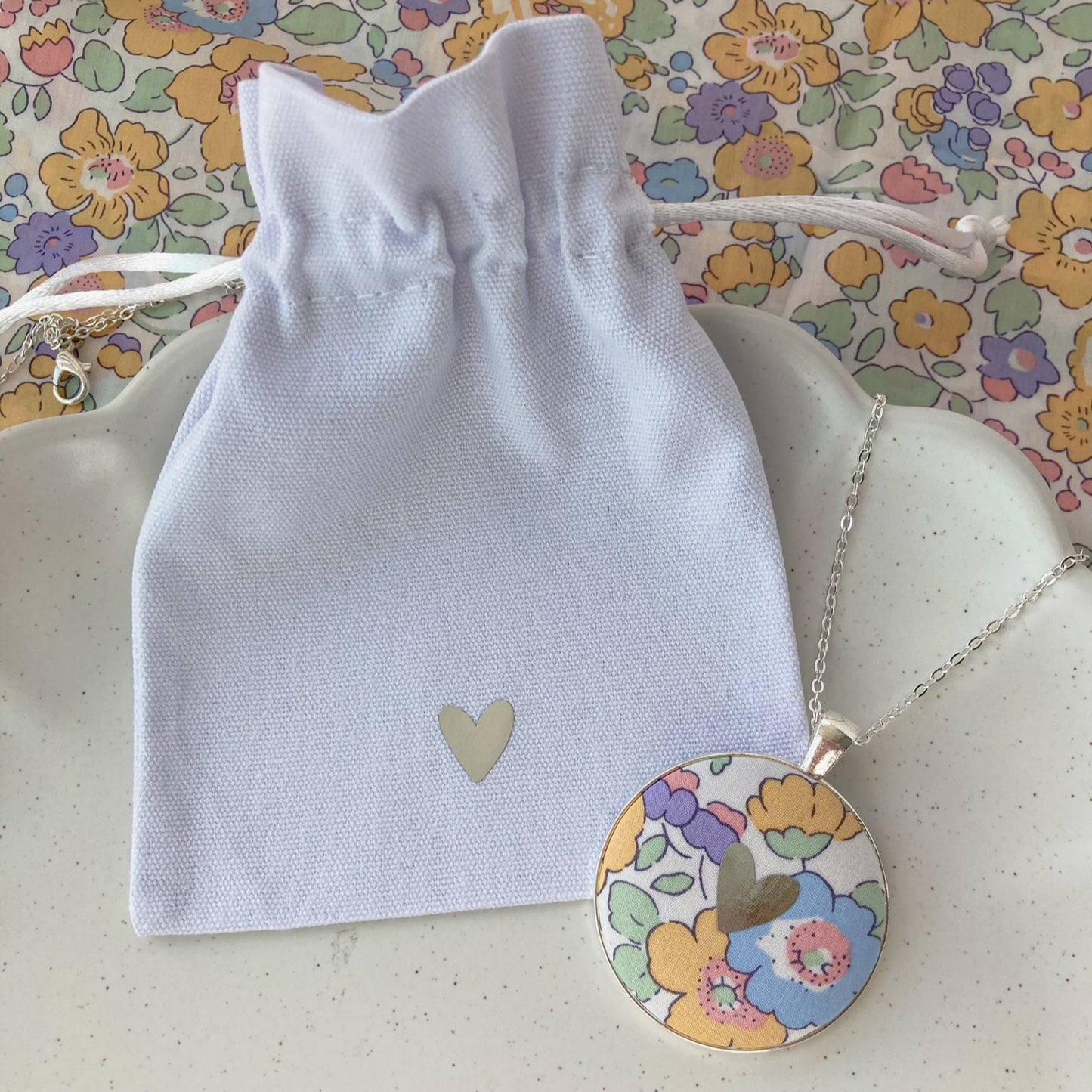 Heart necklace and gift pouch made with yellow and lilac floral fabric