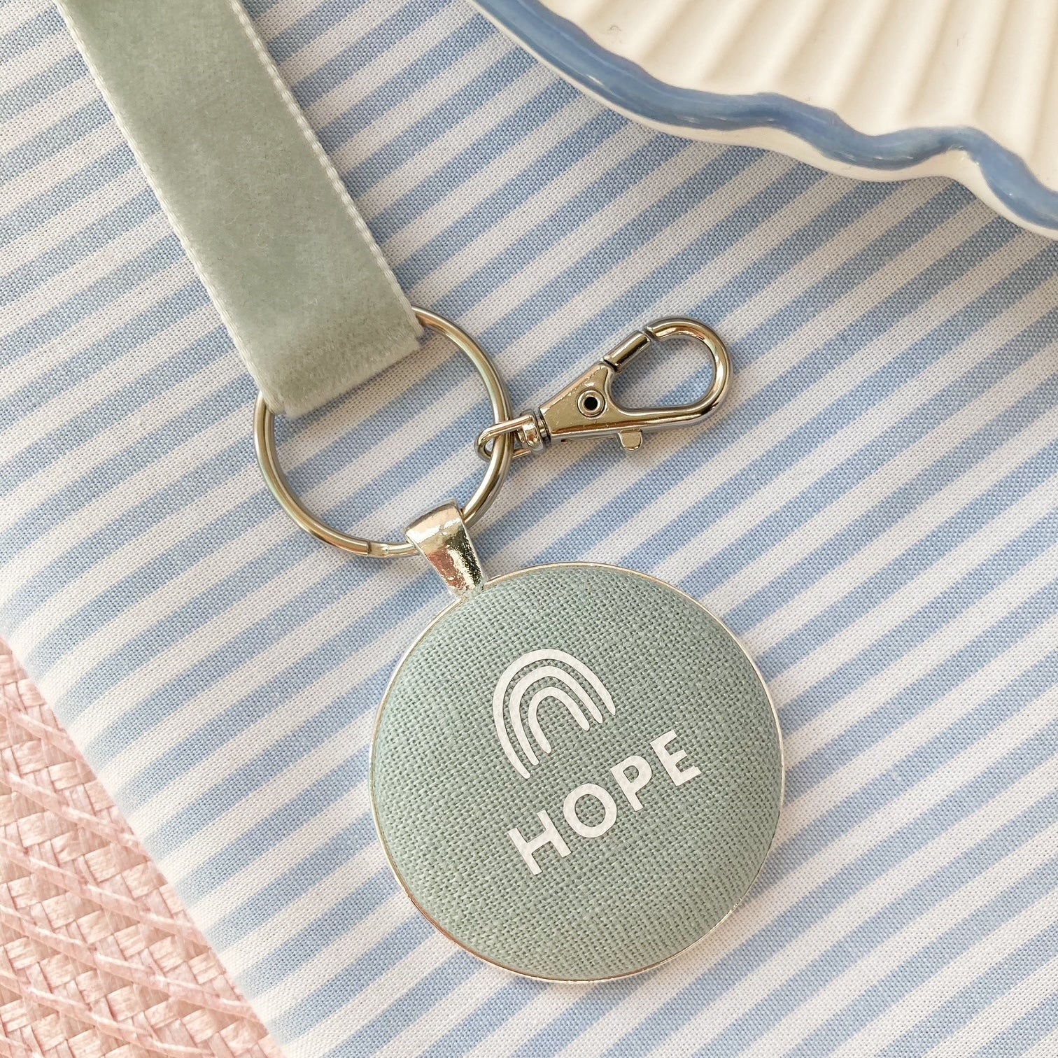 Keepsake with 'HOPE' and rainbow symbol on duck egg blue fabric,  on a striped background