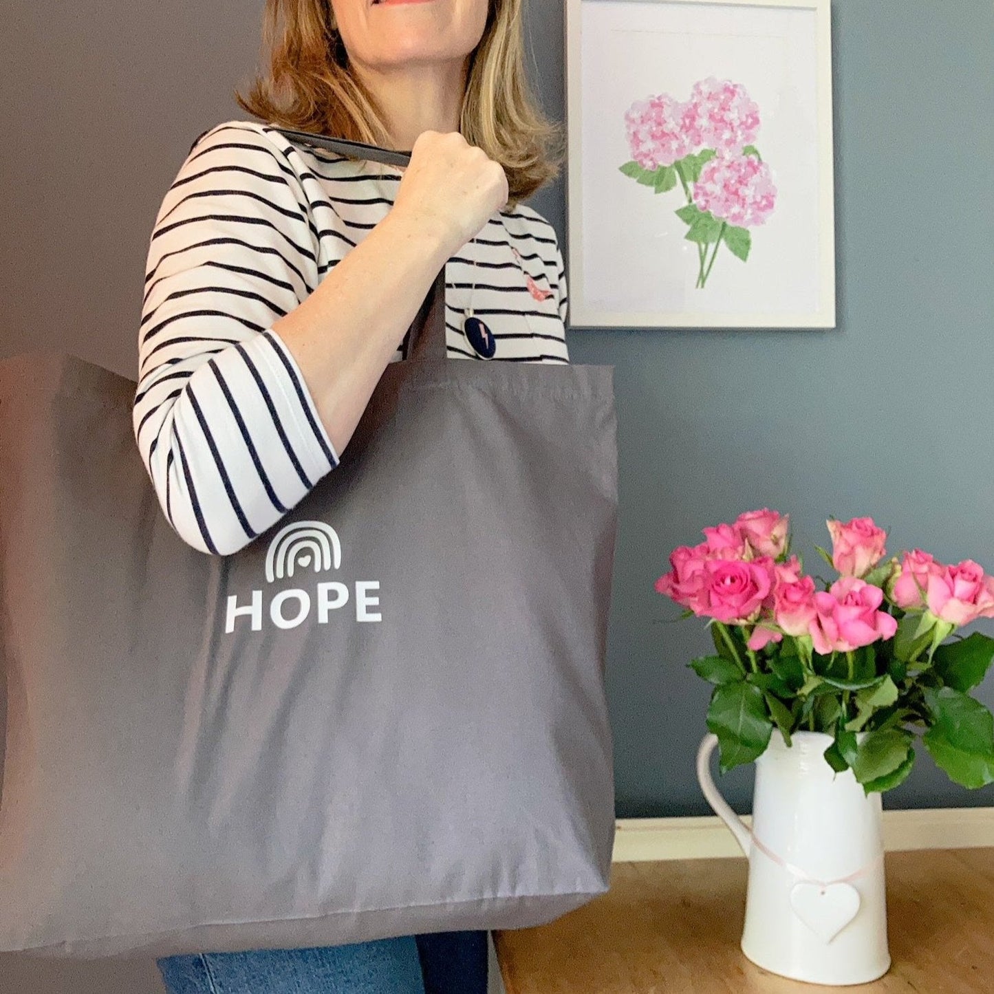 Rainbow tote bag printed with the word Hope