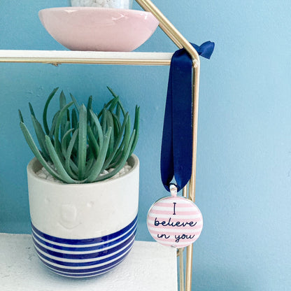 Keepsake with I believe in you printed onto pink and whtie striped fabric, with a navy blue ribbon