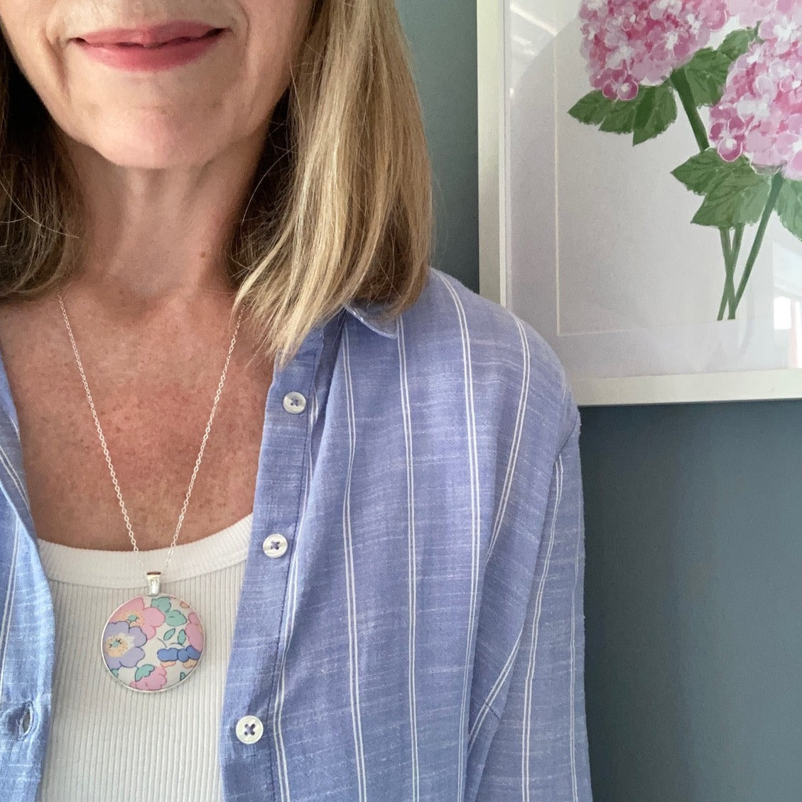 Woman wearing a pink & lilac floral necklaces