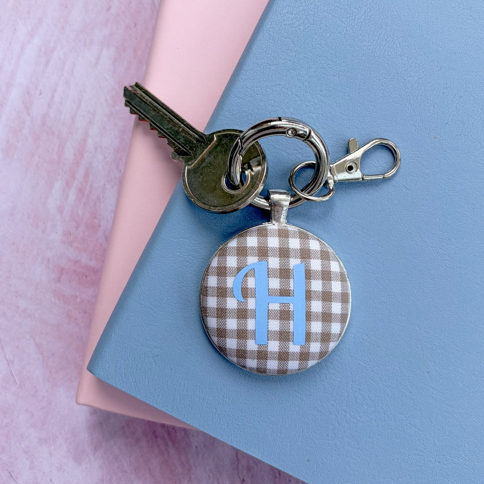 Personalised initial keyring with caramel gingham fabric and a blue H initial