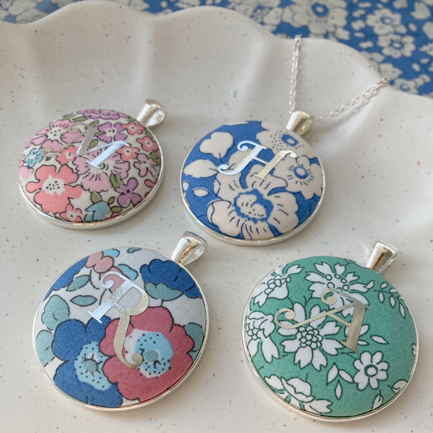 Personalised necklaces with initial printed onto floral Liberty fabrics