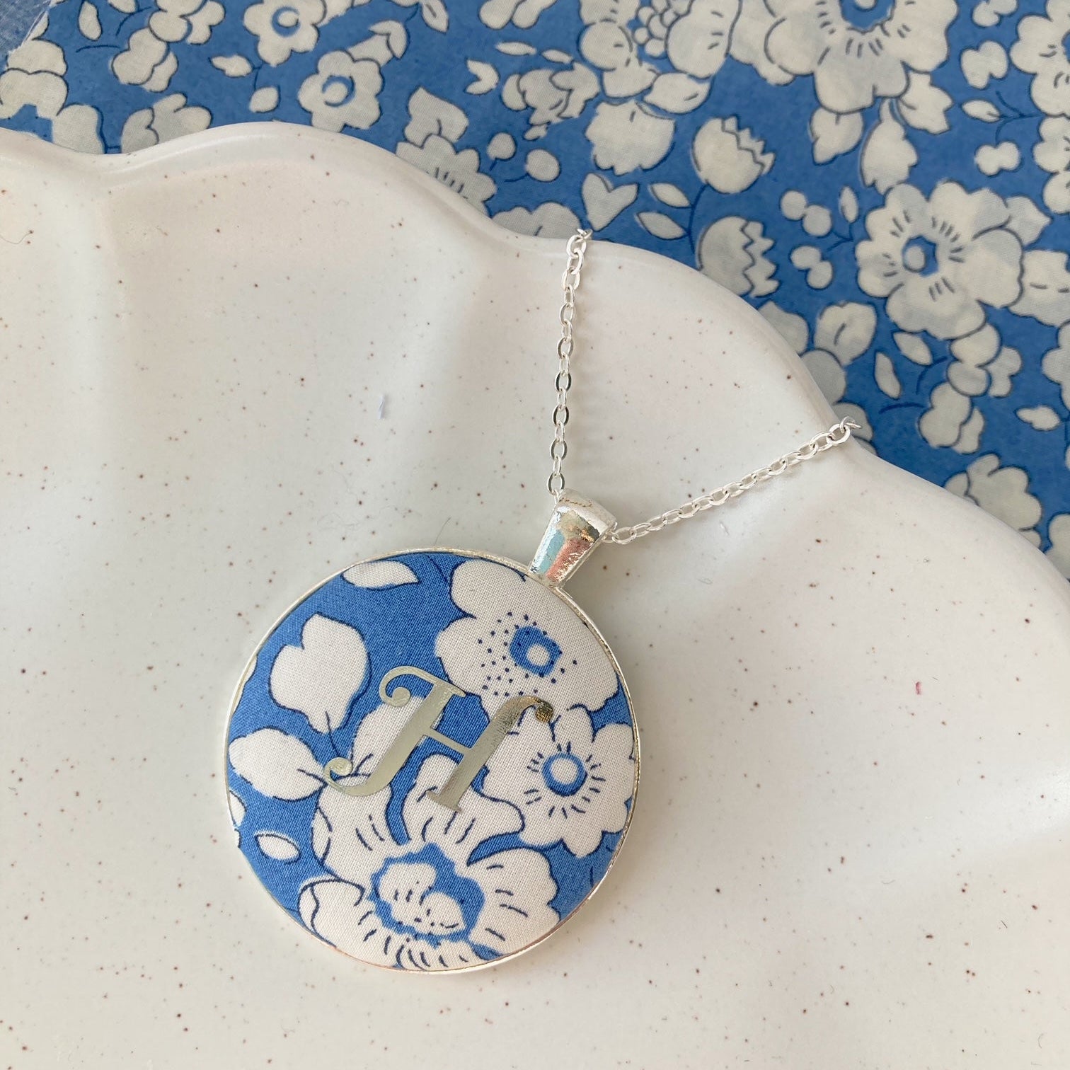 Personalised initial necklace on blue Liberty fabric