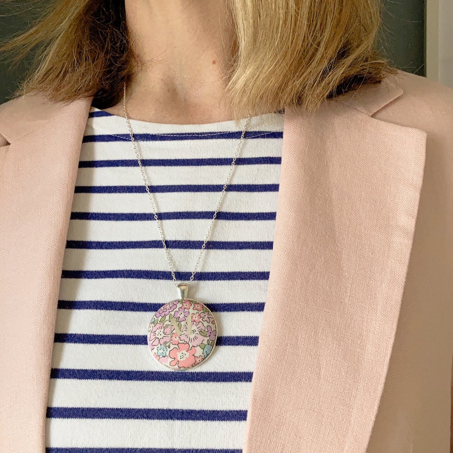 Initial necklace on pink Liberty fabric worn with a stripy top