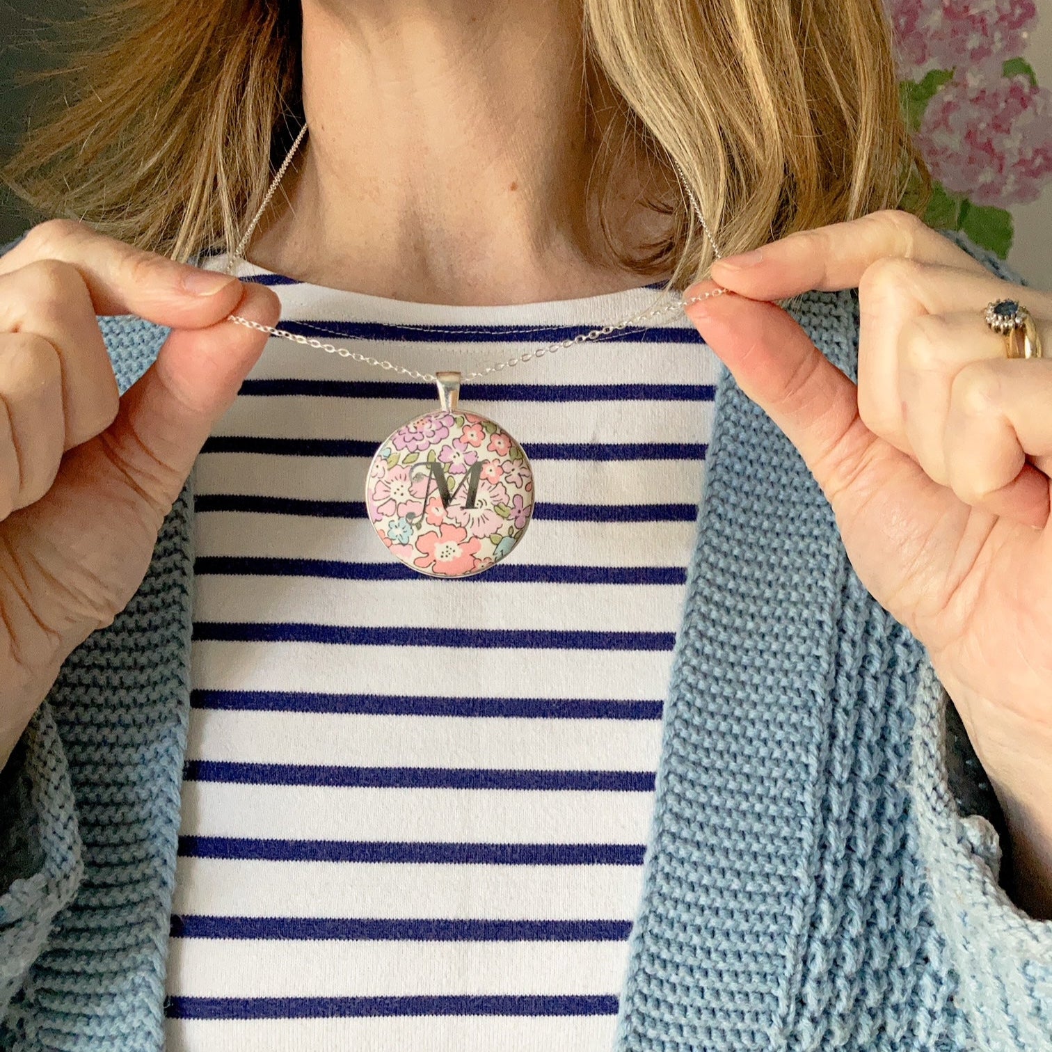 Initial personalised necklace on pink floral fabric