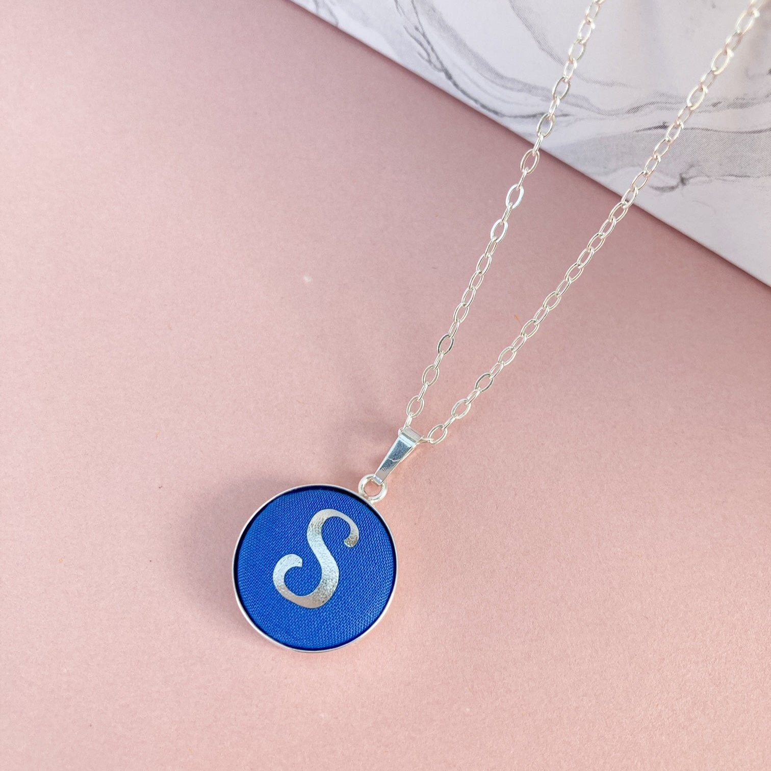 Blue fabric initial necklace with S in silver foil