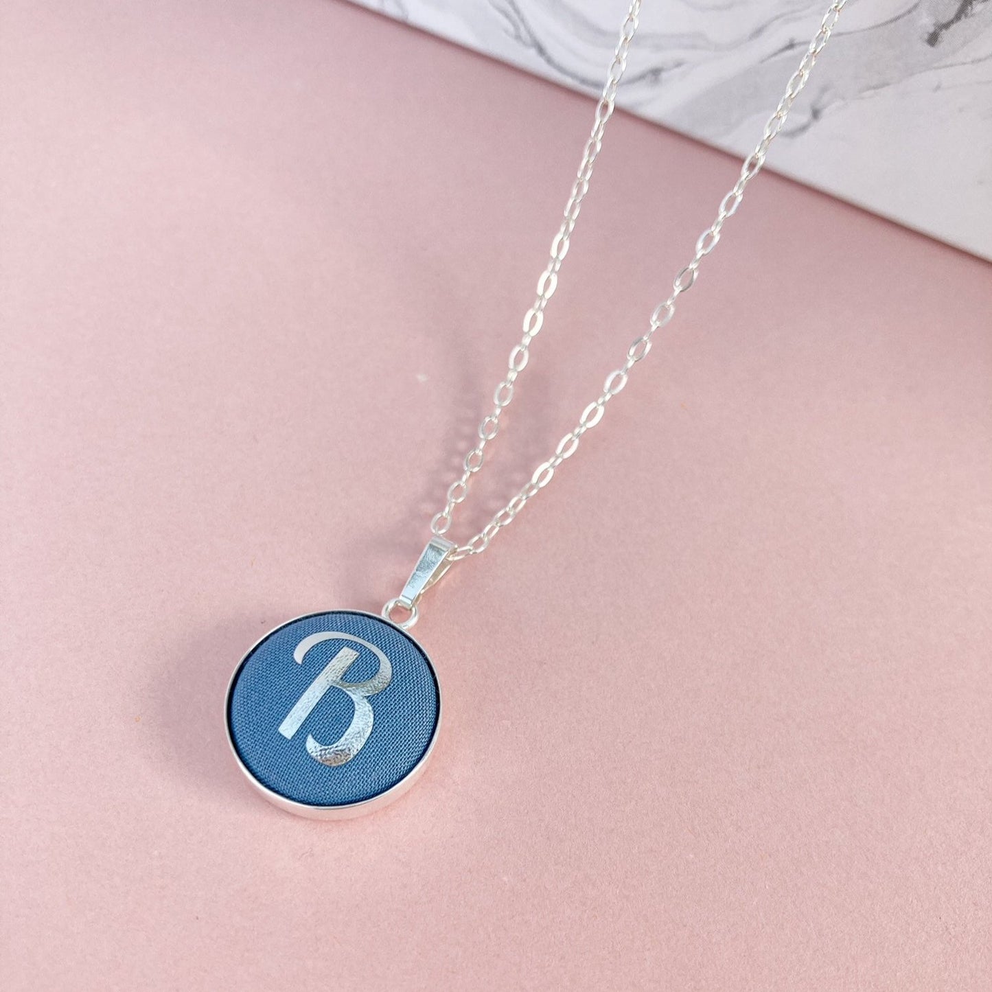 Initial necklace in blue with letter B in silver foil