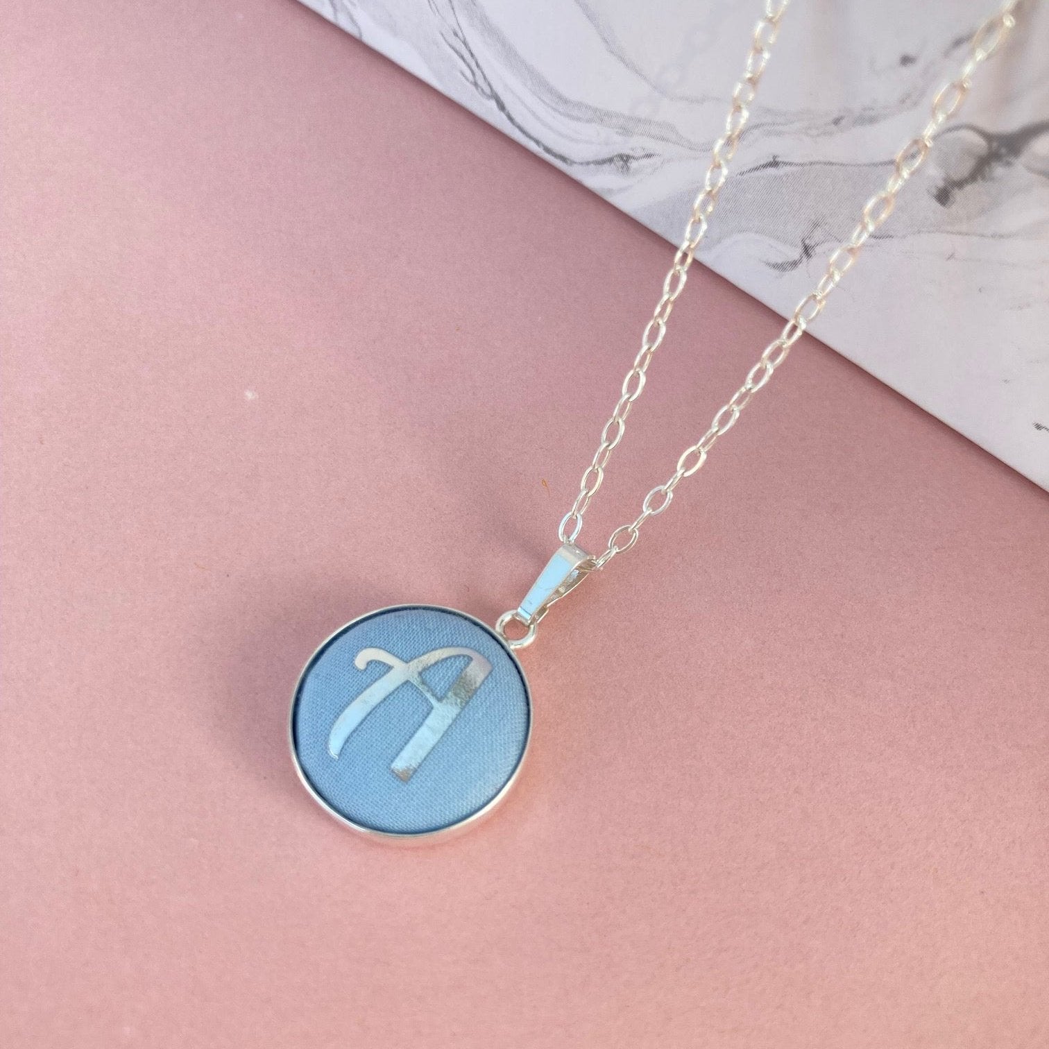 Pale blue initial necklaces