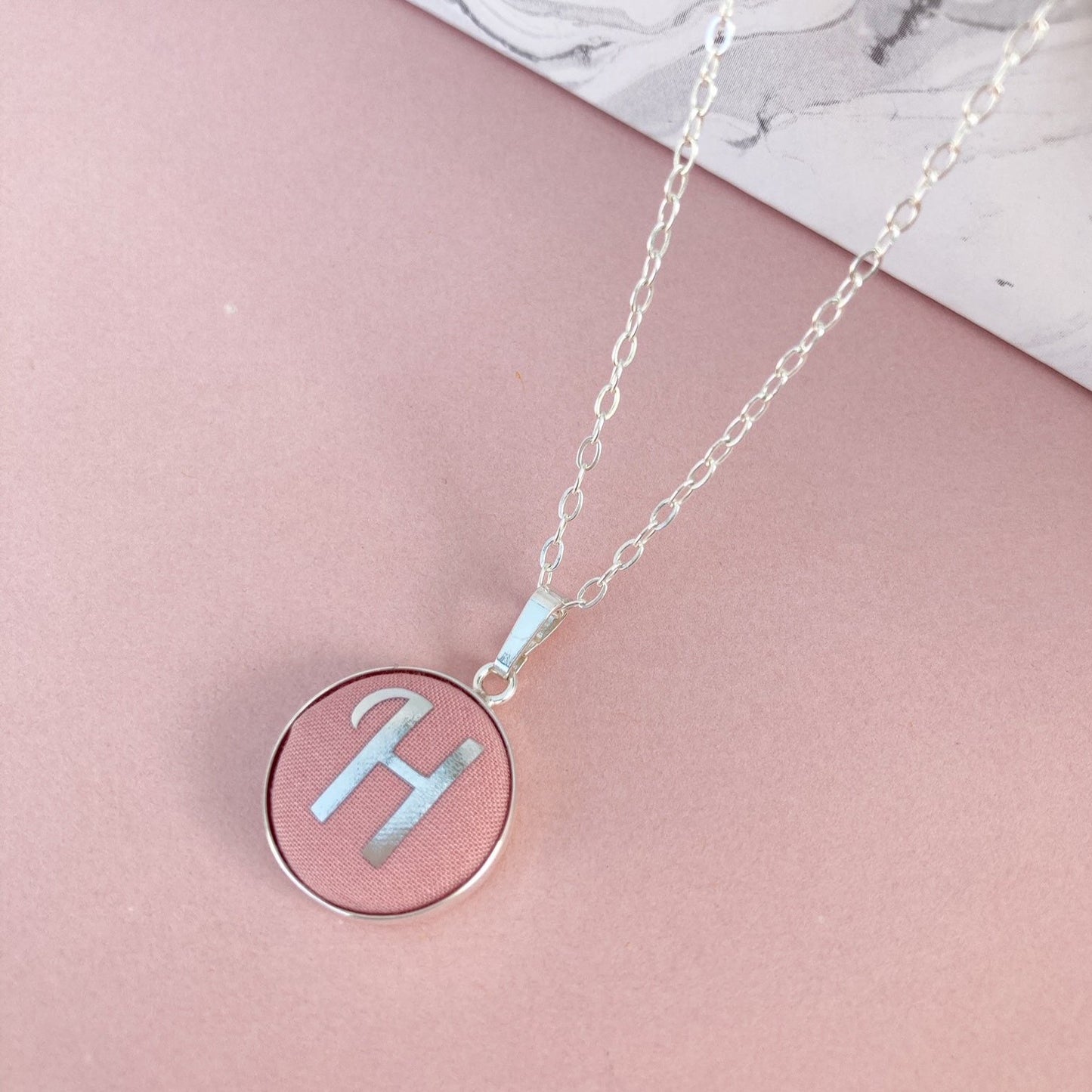 Initial necklace in rose pink fabric with H initial