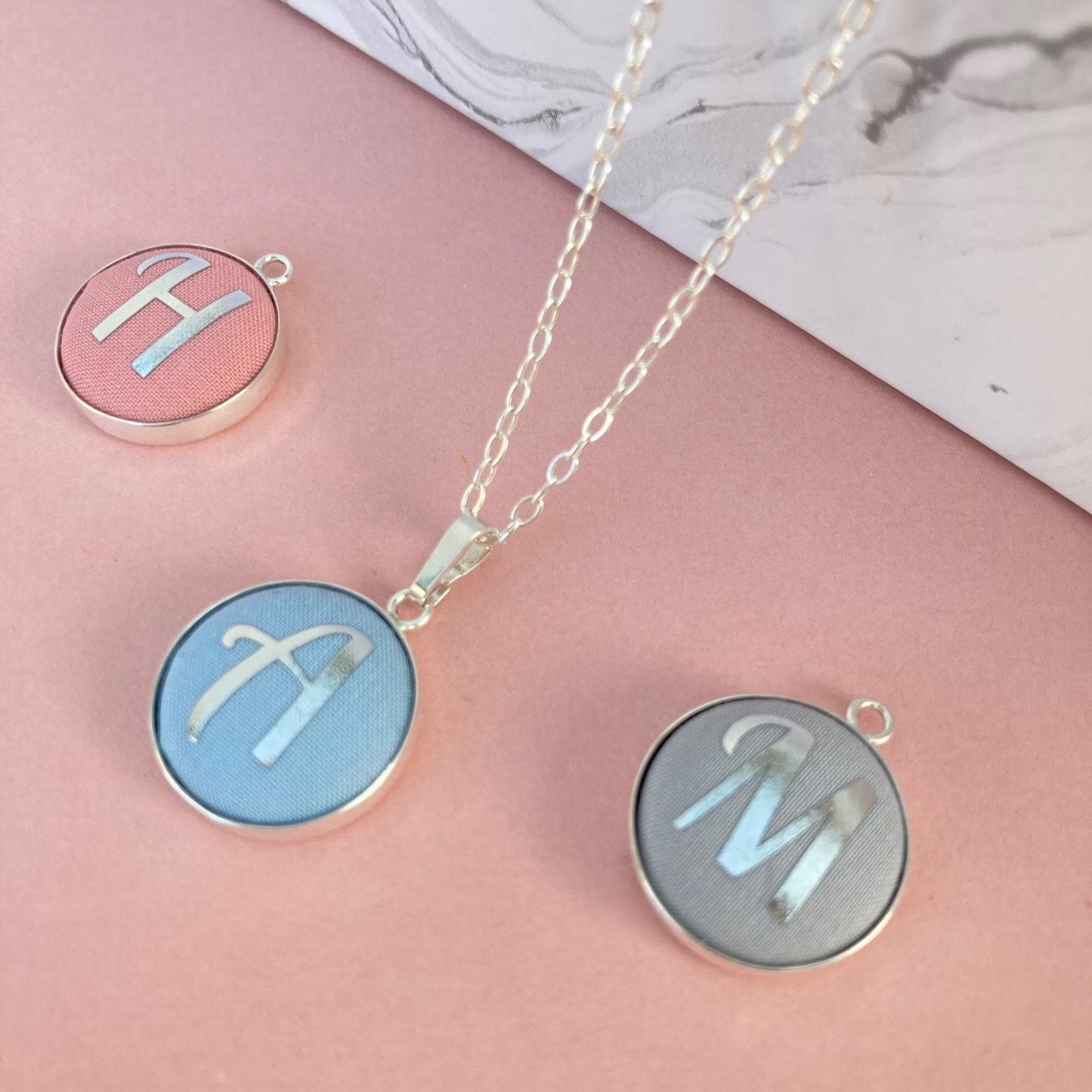 Pastel shades initial necklaces with silver foil letters