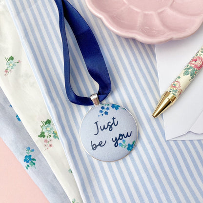 Just Be You Thoughtful Keepsake on blue floral Liberty fabric with a blue ribbon