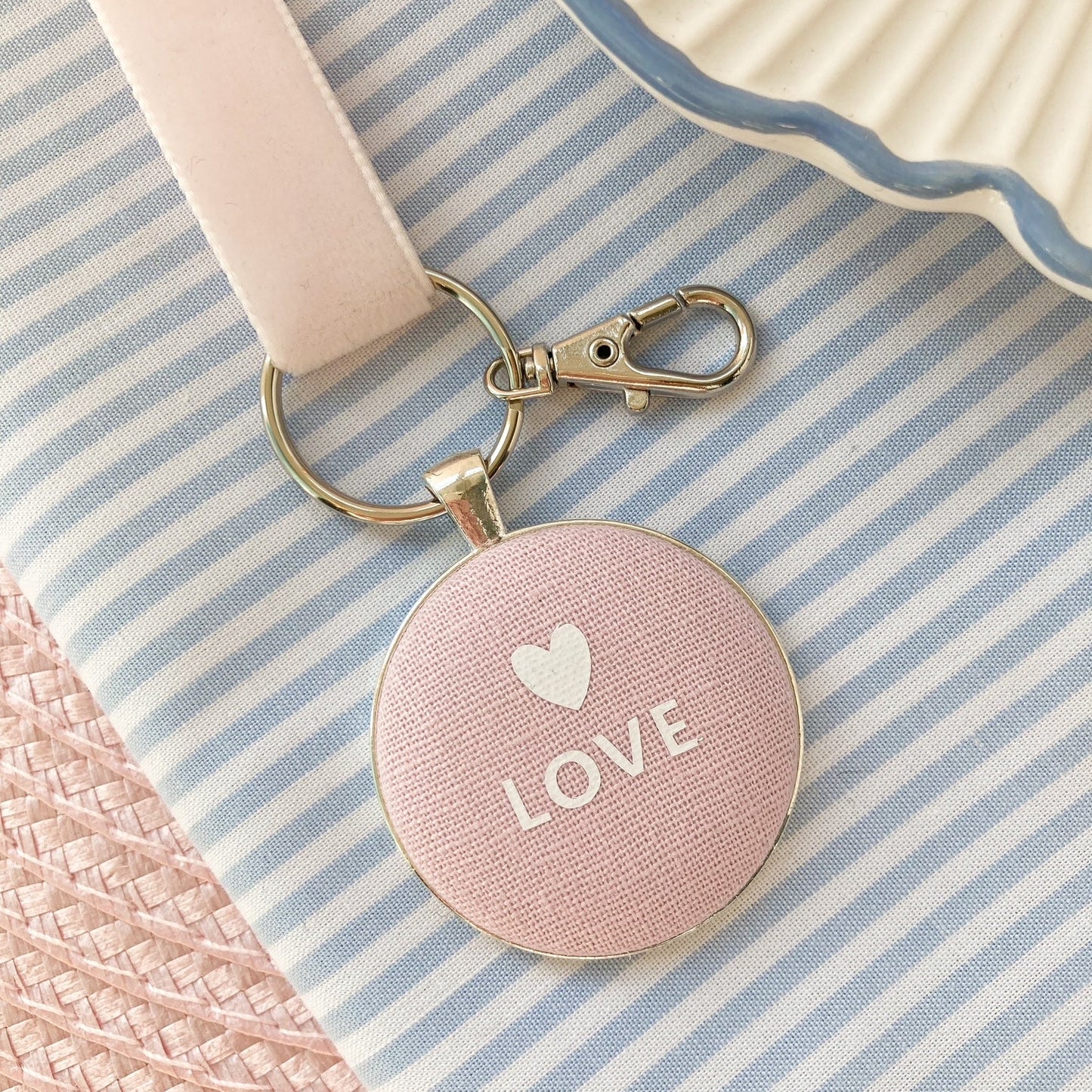 Pink keyring and keepsake with 'LOVE' and a heart on pink linen fabric with a velvet ribbon