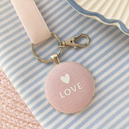 Pink keyring and keepsake with 'LOVE' and a heart on pink linen fabric with a velvet ribbon