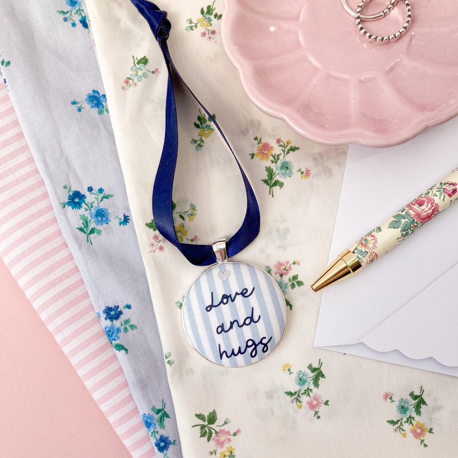 Love and Hugs keepsake made with blue and white striped fabric and a navy blue ribbon
