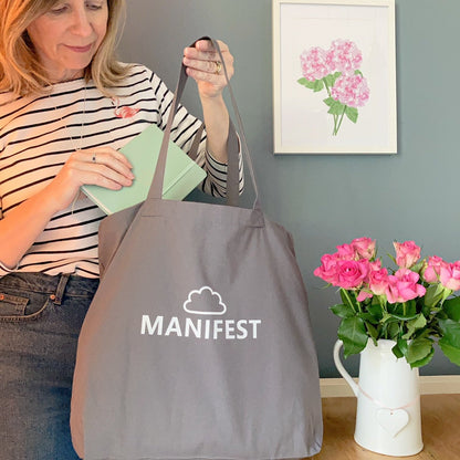 Large roomy grey tote bag printed with Manifest in white