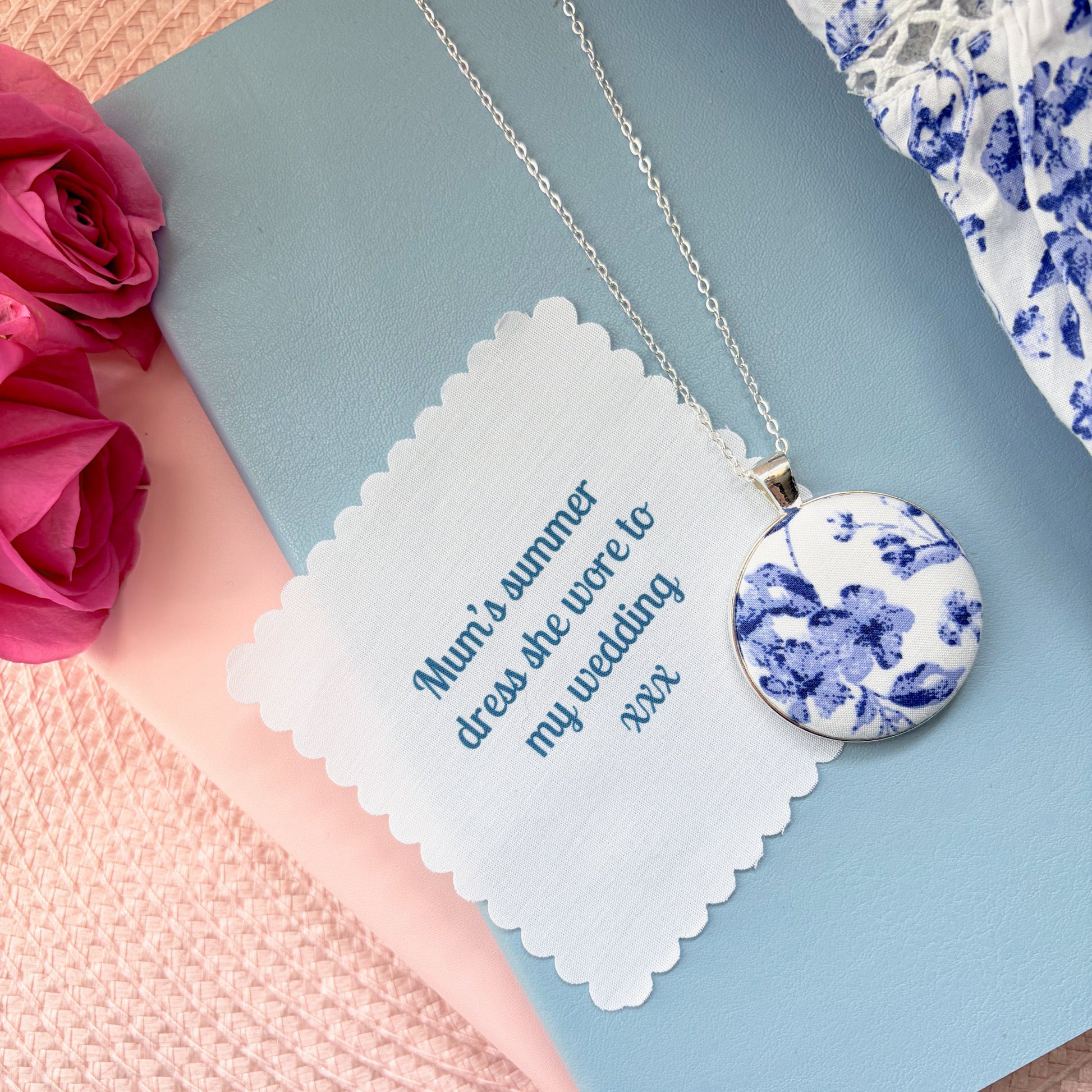 Blue floral fabric necklace with a fabric printed message