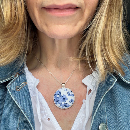 Lady wearing a blue floral pendant