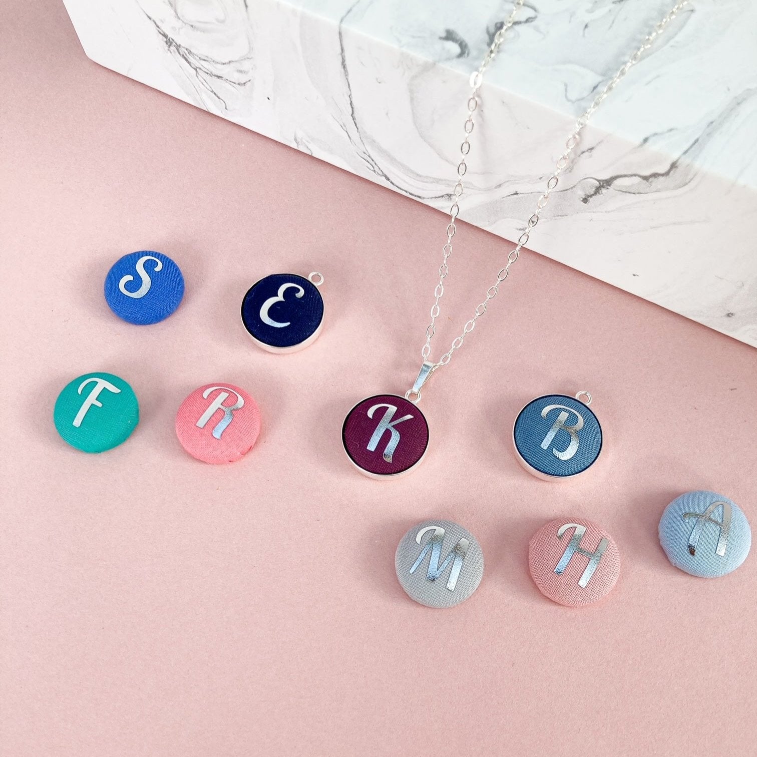 Initial necklaces in various colour with silver foil letters