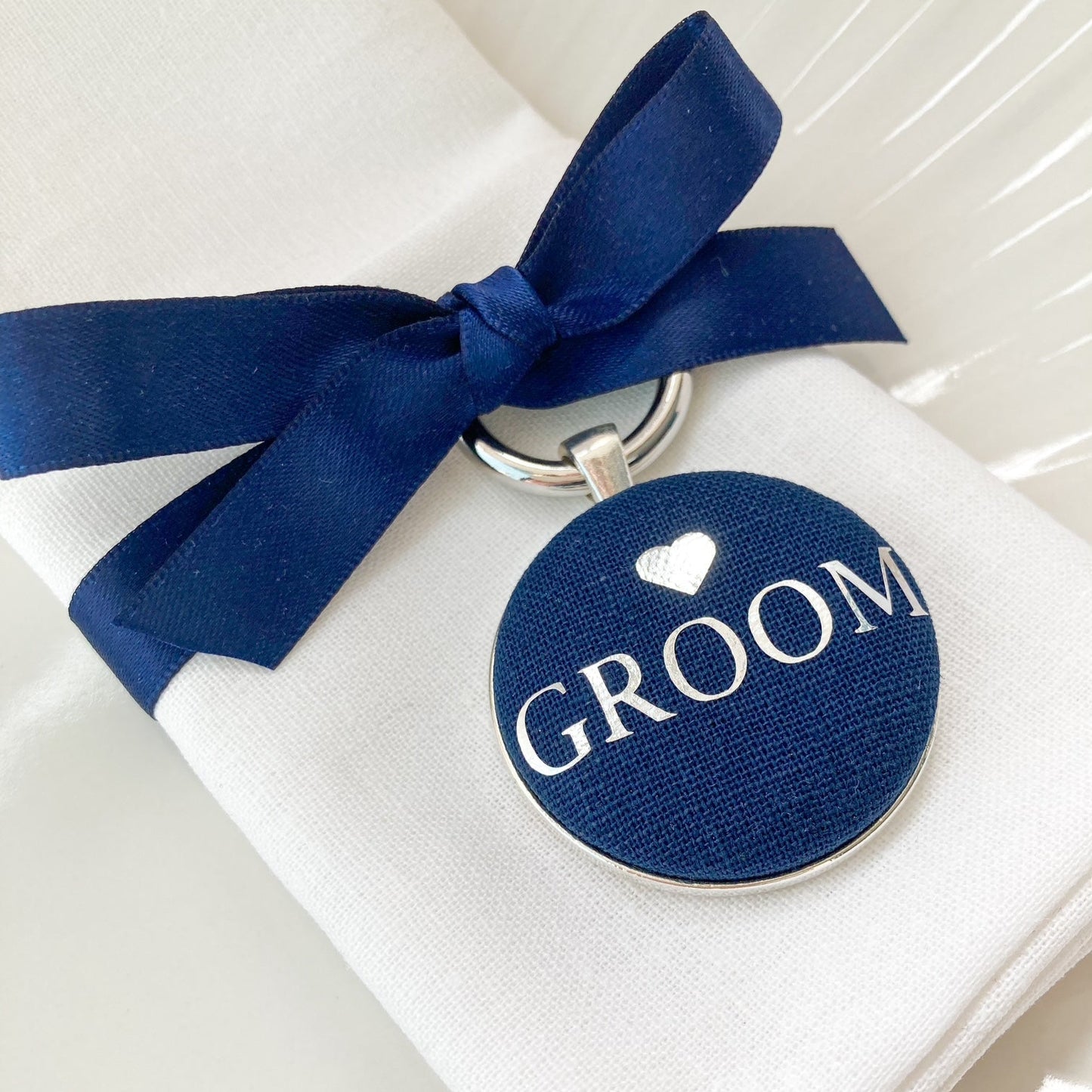 Navy groom wedding breakfast place setting and favour with ribbon