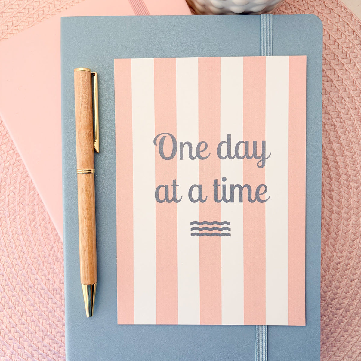 One Day At A Time postcard with a pink and white striped design 