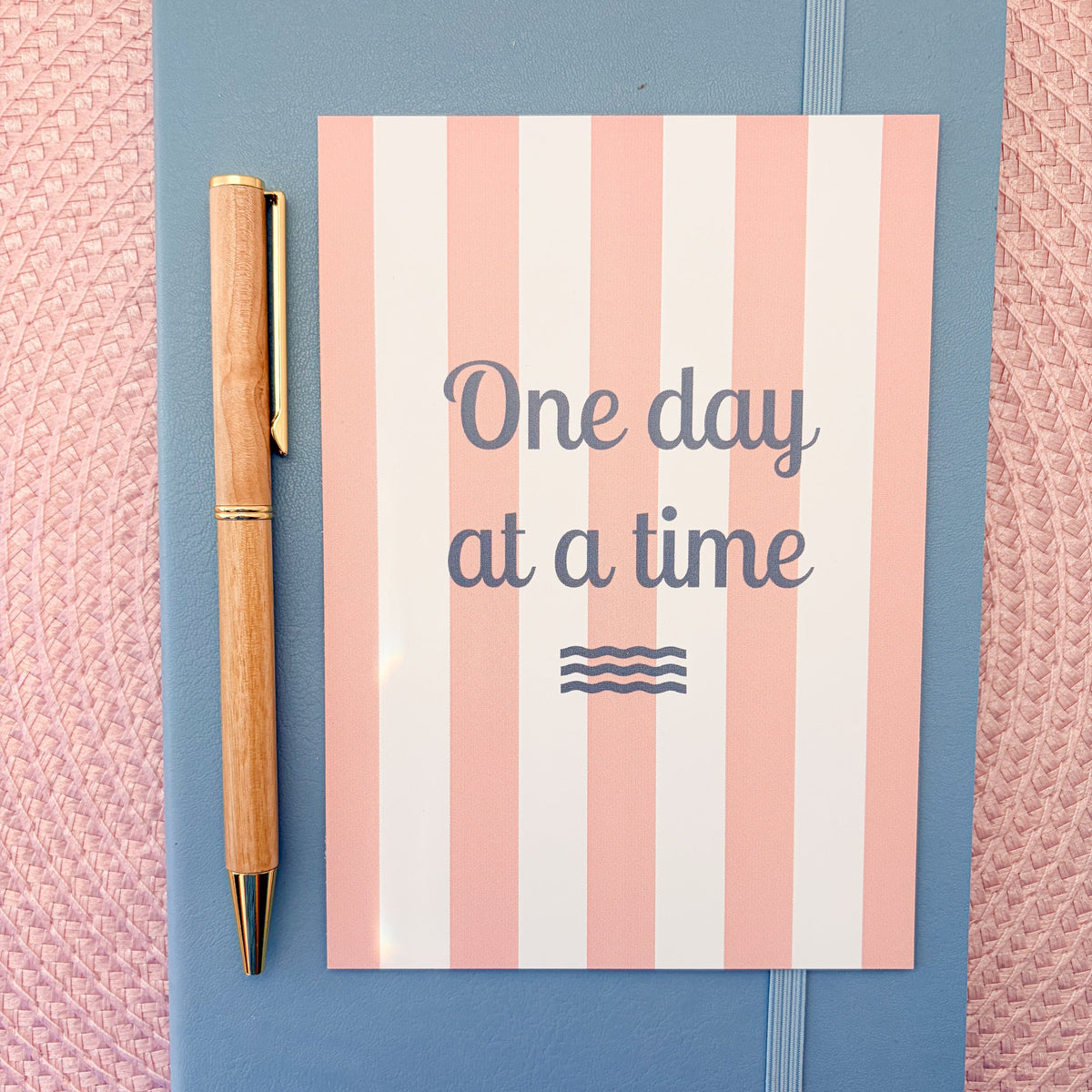 One Day At A Time postcard with a pink and white striped design 