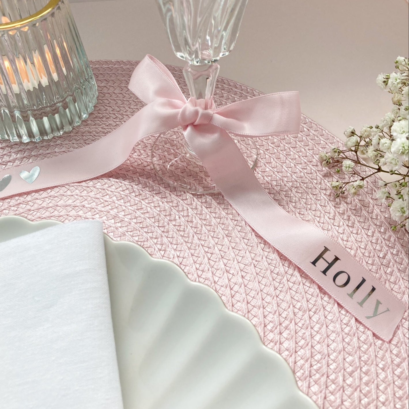 Personalised ribbons for wedding place setting in pink satin with name in silver