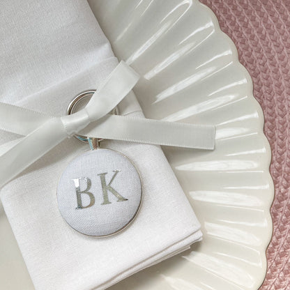 Personalised wedding breakfast and favour keyring in white linen fabric with initials