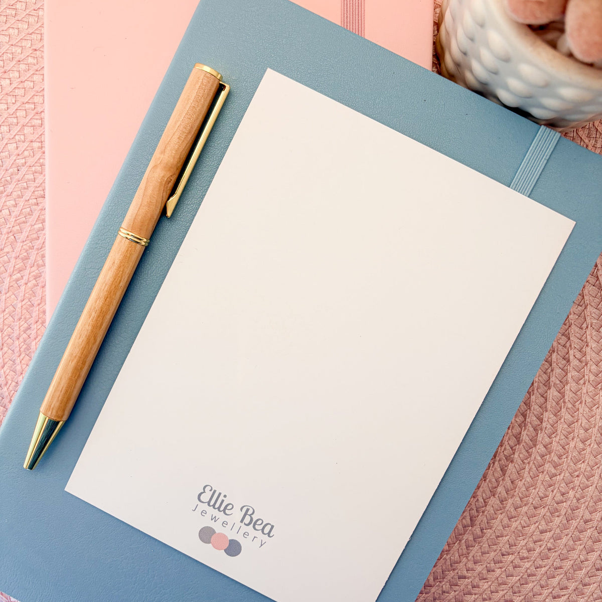 The white reverse side of a pink and white striped postcard with You've Got This written in blue with a blue lightning symbol